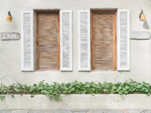 DIY interior window shutters fitted inside a UK home window, showing panel alignment and frame depth